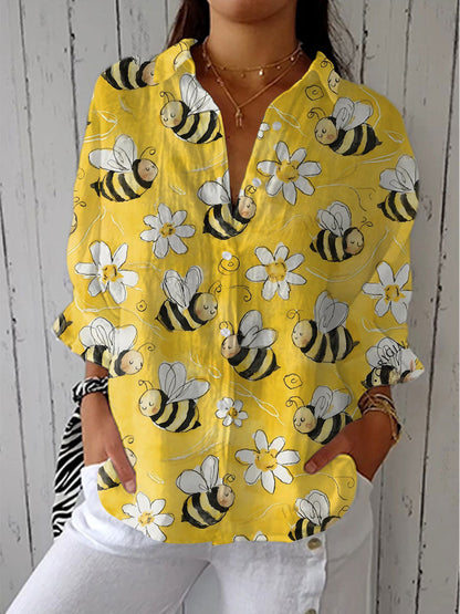 Yellow long-sleeve blouse with button front, V-neck, bee and flower print