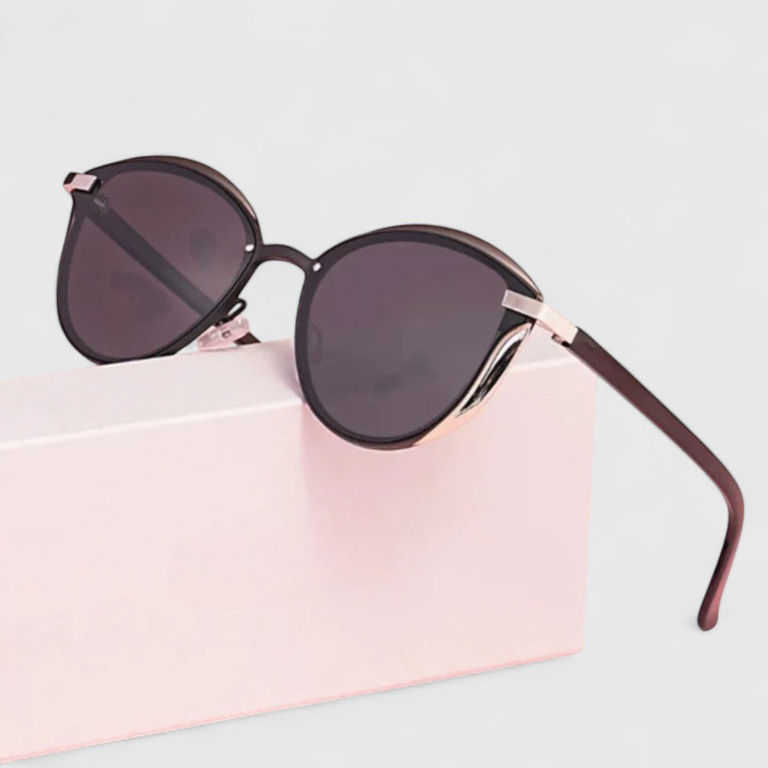 Dark mirrored round sunglasses with black lenses and gold bridge detail