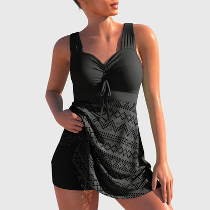 Black two-piece swimsuit with skirt overlay, ruched cups and tie-front neckline