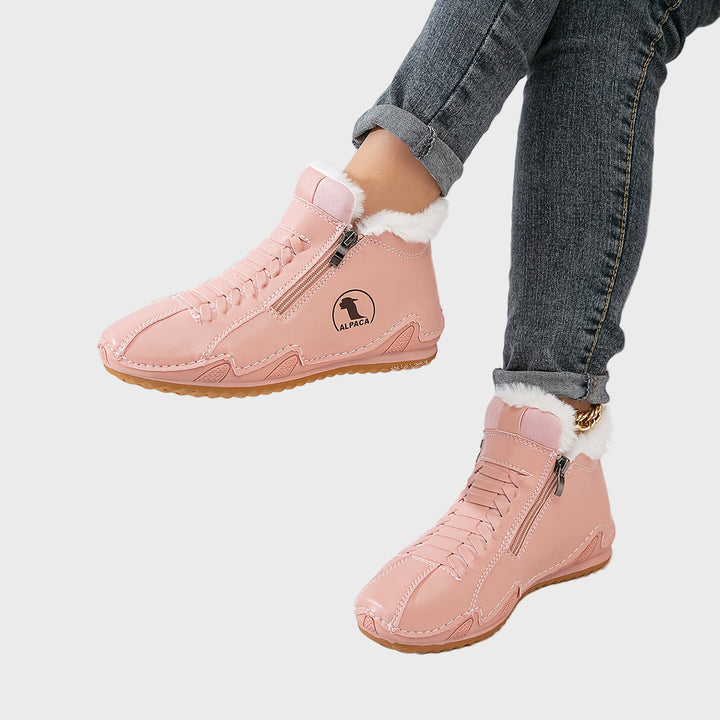 Pink ankle boots with faux fur cuff, side zipper, lace-up design, and tan sole.