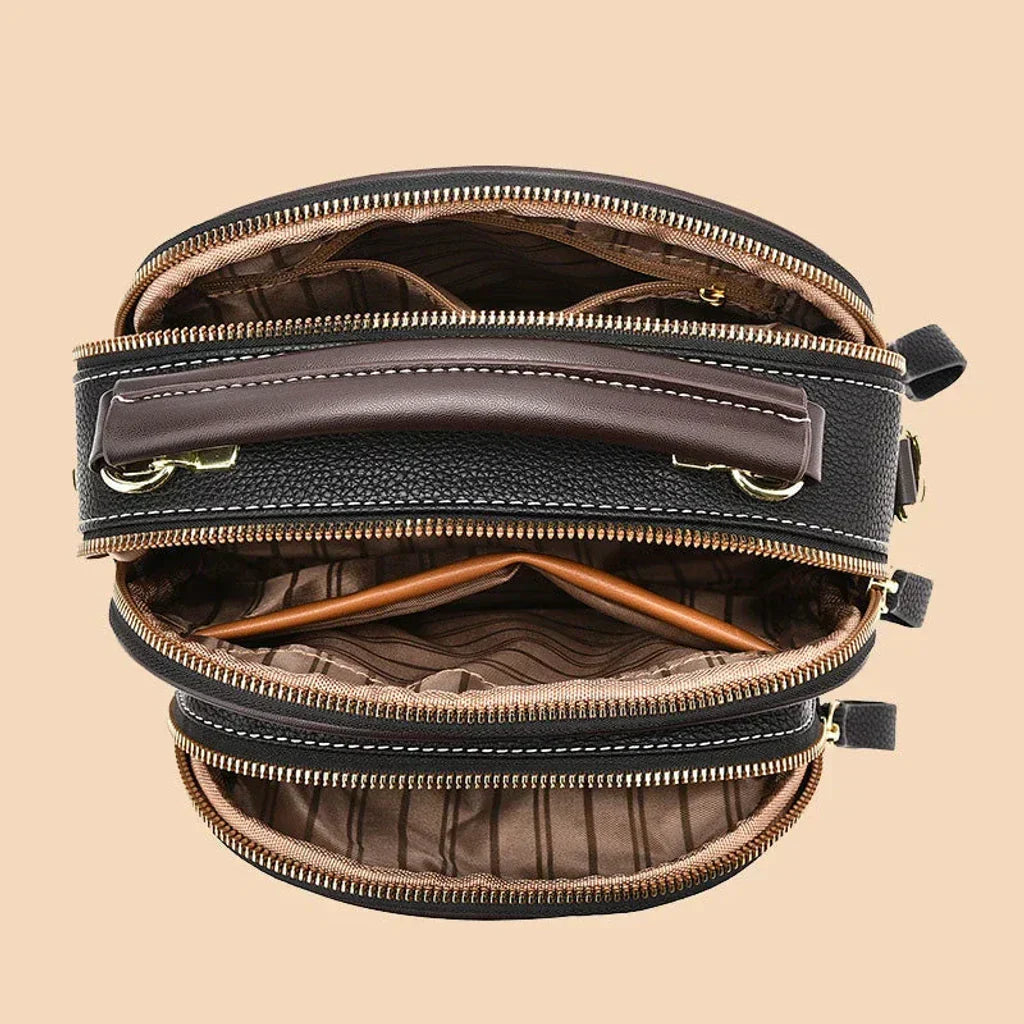 Mini crossbody bag interior view with fabric lining and multiple zippered compartments