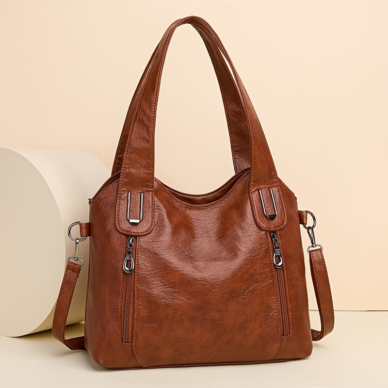 Lumi women’s classic tote bag in brown with dual handles, top zip, and shoulder strap