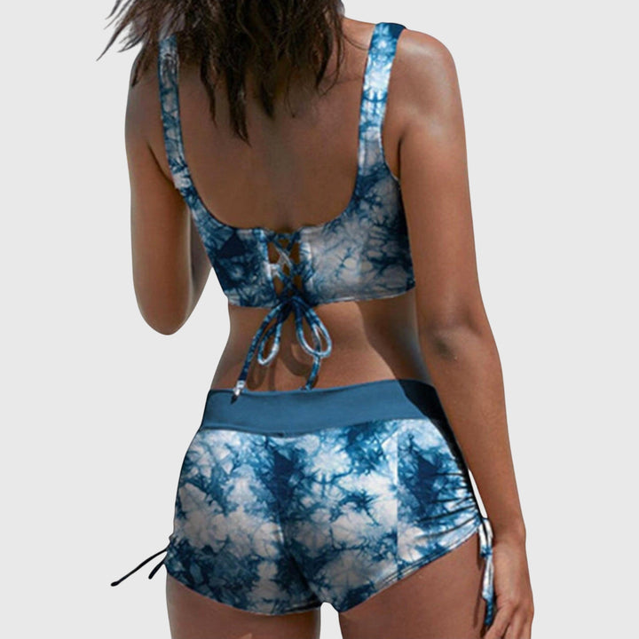 Blue tie-dye bikini set back view with lace-up neckline and ruched side-tie shorts