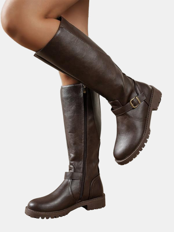 Dark brown leather low-heel boots with side zip, buckle strap, and lug outsole