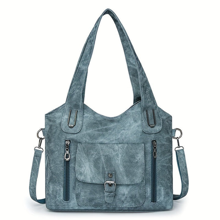 Sky blue suede-look shoulder bag with top handles, flap pocket, and side zippers
