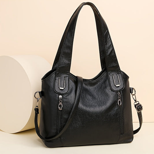 Lumi women’s classic tote bag in black with two handles, top zip, and side straps