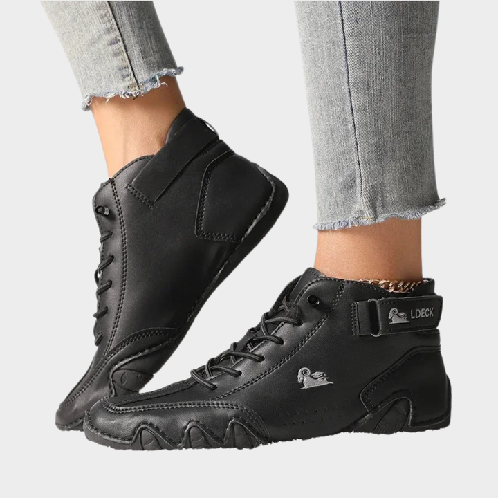 Black orthopedic ankle boots with lace-up front, padded collar, thick sculpted sole