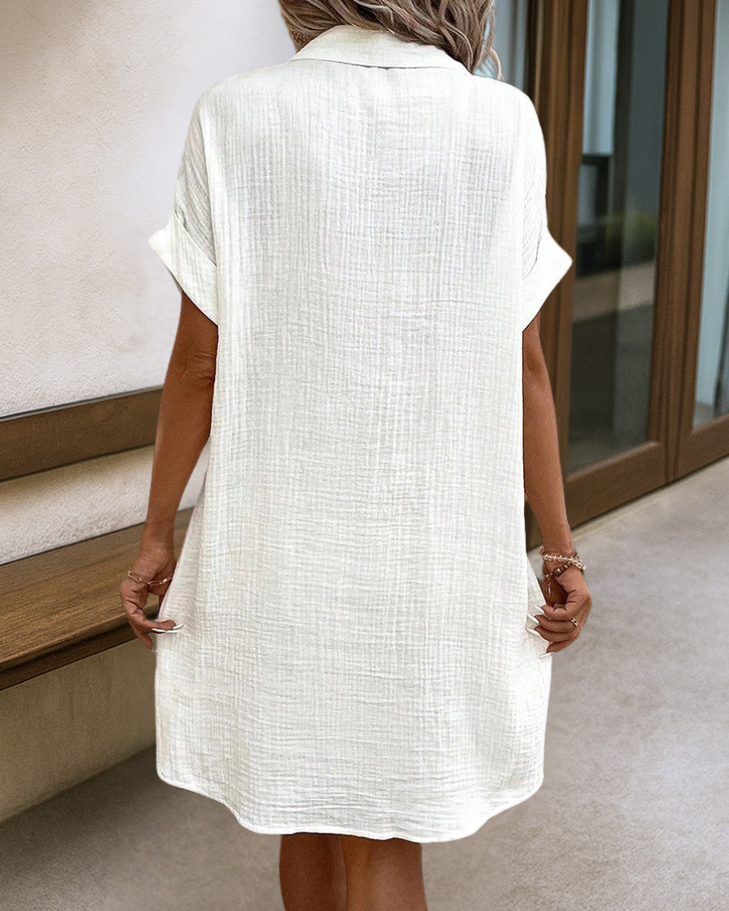 White midi button-front dress, short sleeves, with relaxed back yoke detail.