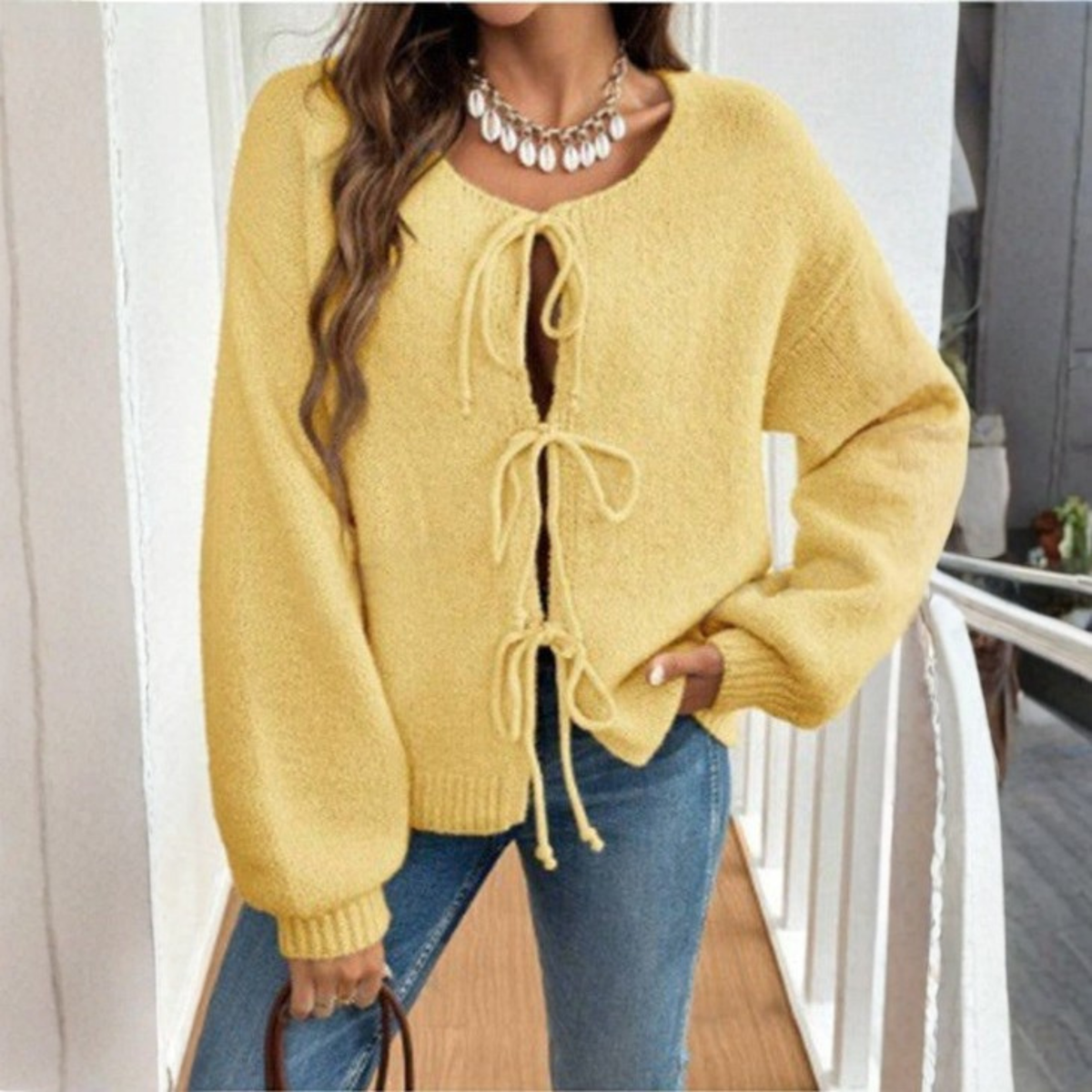 Yellow tie-front cardigan with round neck and drawstring lacing, long sleeves