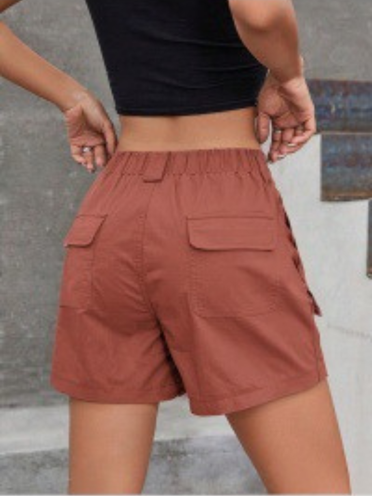 Rust pink cargo shorts with two cargo flap pockets and button front