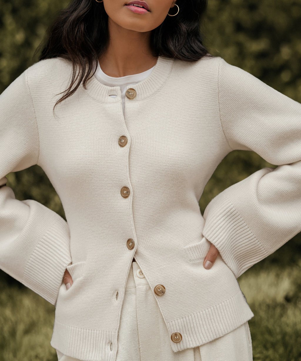 Cream cardigan sweater with button front and patch pocket detail