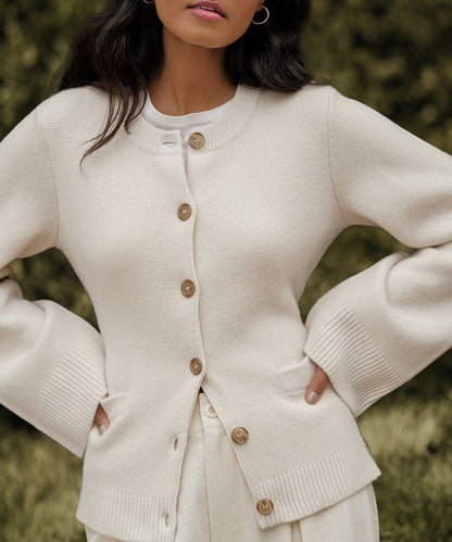 Cream cardigan sweater with button front and patch pocket detail