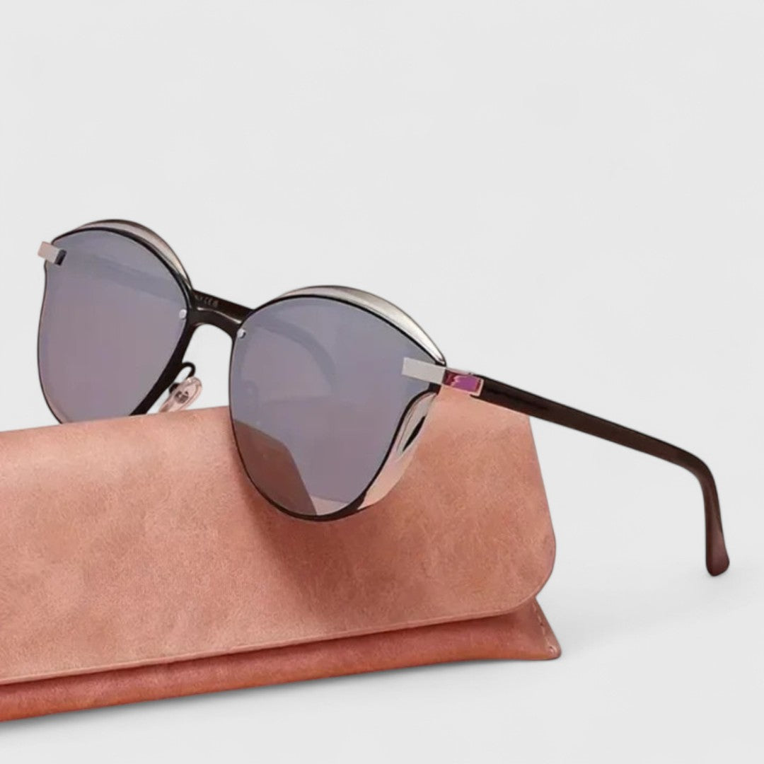 Dark gray mirrored round sunglasses with gold bar detail and brown-tinted temples