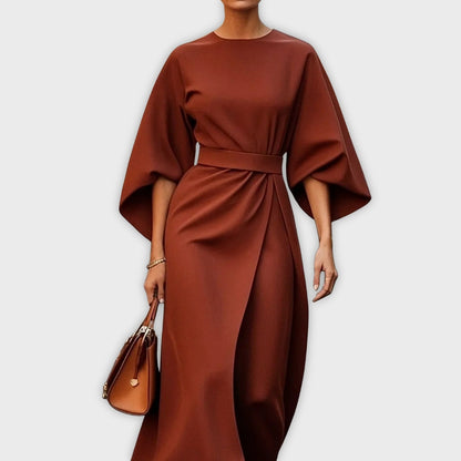 Reddish brown belted dolman sleeve midi dress with waist tie and draped skirt.