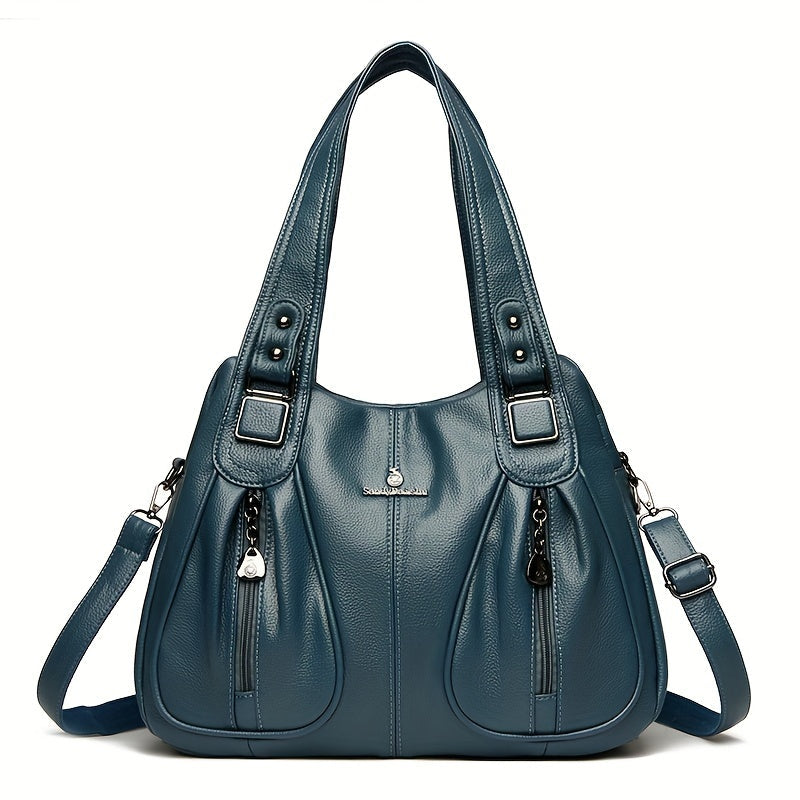 Women’s casual shoulder bag in blue with top handles and adjustable shoulder strap.