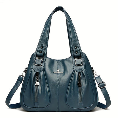 Women’s casual shoulder bag in blue with top handles and adjustable shoulder strap.