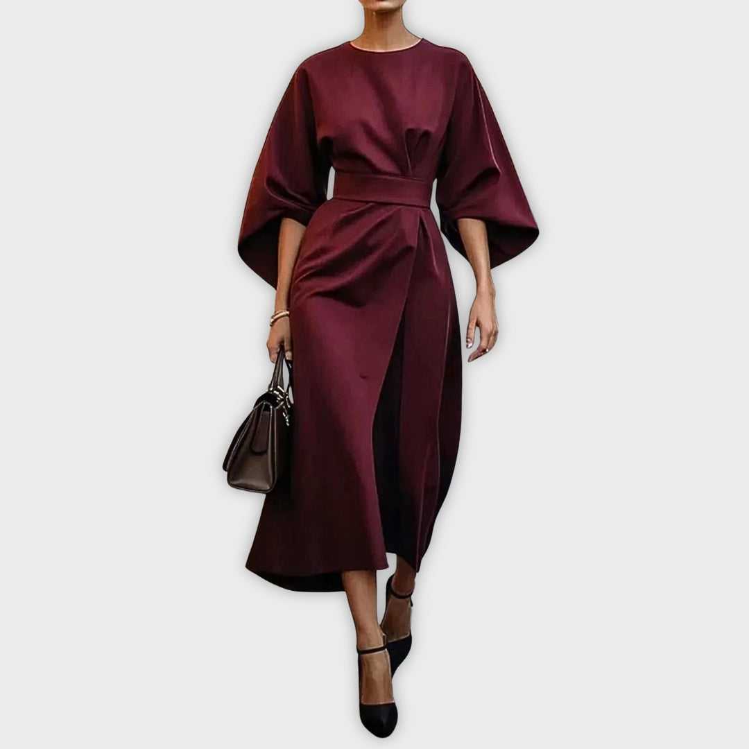 Red wine belted dolman sleeve midi dress with waist tie and draped skirt.