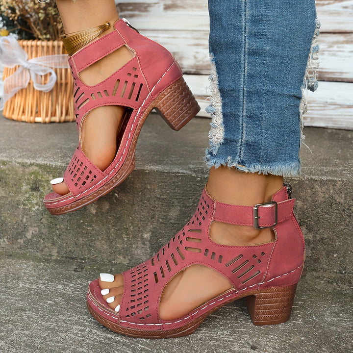 Pink ergonomic sandals with perforated cutouts and ankle buckle strap