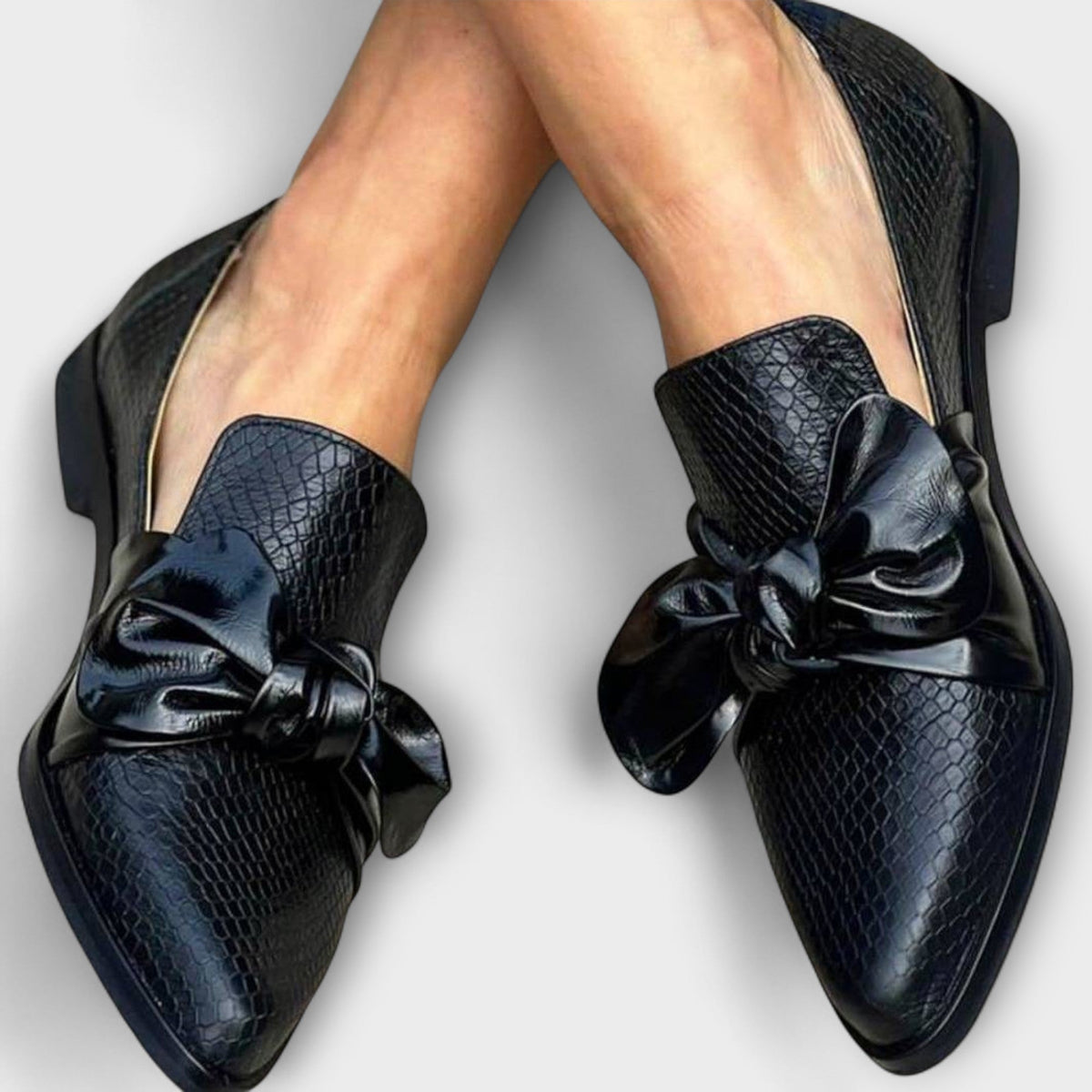 Erica loafers in dark navy with snake-textured uppers and glossy knotted bow
