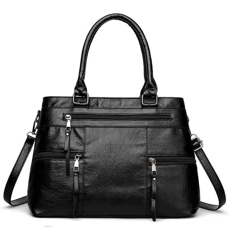 Black leather women’s tote bag with double top handles, front zip pocket and detachable strap