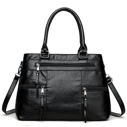 Black leather women’s tote bag with double top handles, front zip pocket and detachable strap