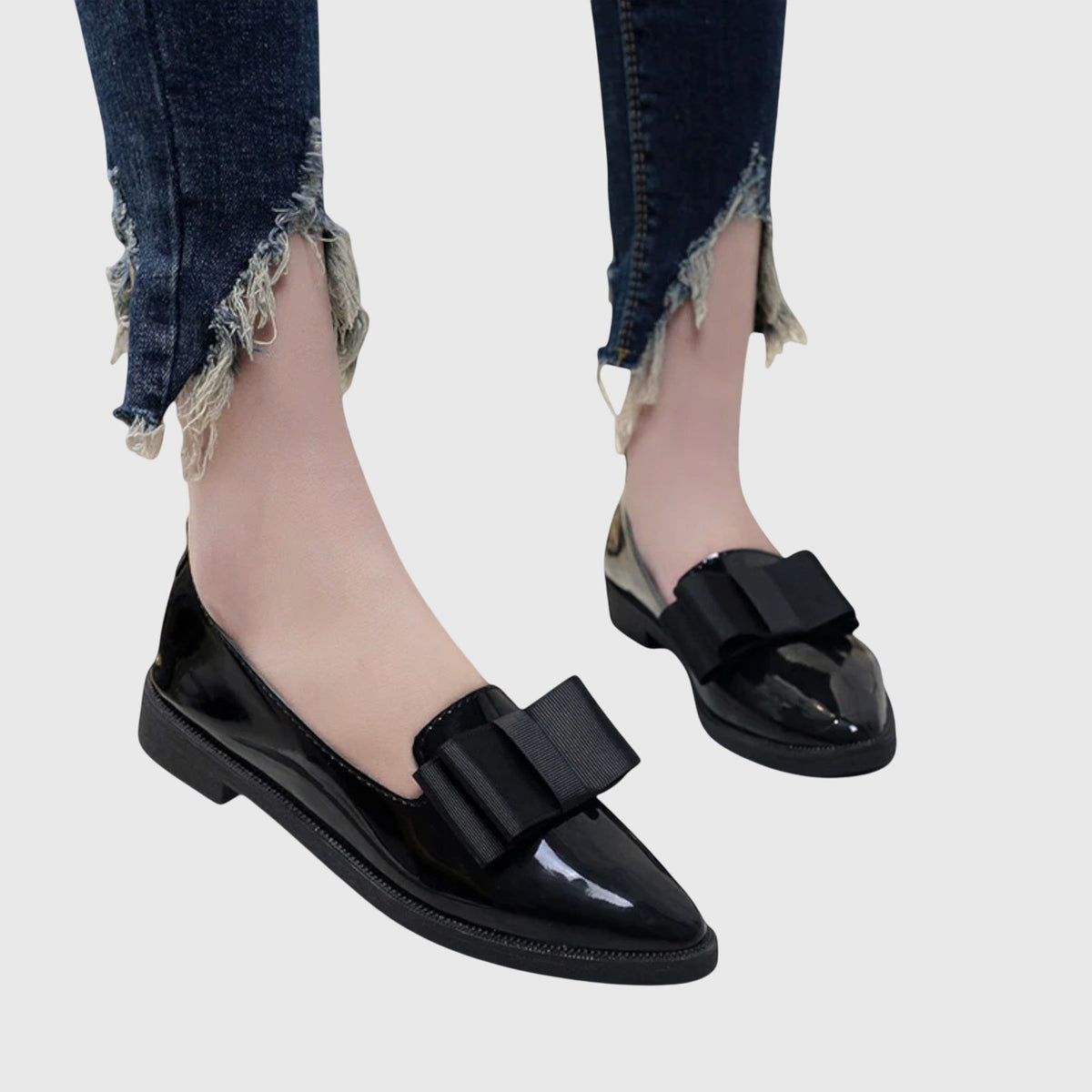 Black glossy loafer with wide strap across the top and thick cushioned sole