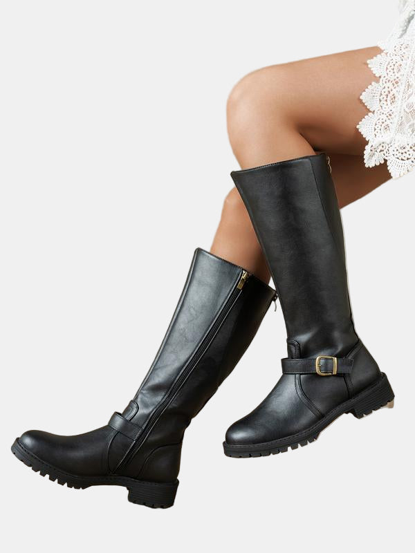 Black leather low-heel boots with buckle strap, side zip, and chunky lug sole