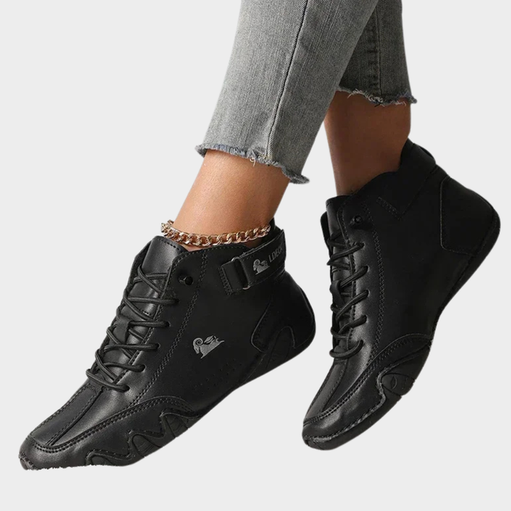 Black orthopedic ankle boots with lace-up closure, elastic side tabs, sculpted cushioned sole