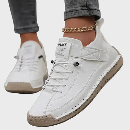Orthopedic sneakers in white with lace-up front, padded collar, and stitched rubber sole