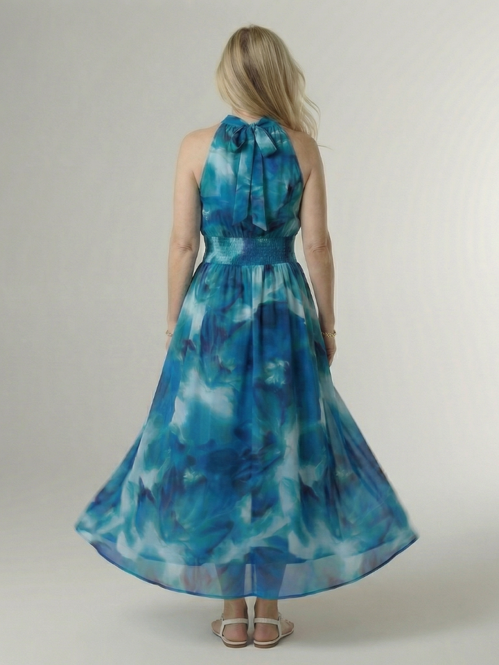 Blue gathered halter midi dress back view with tied neck and smocked waist