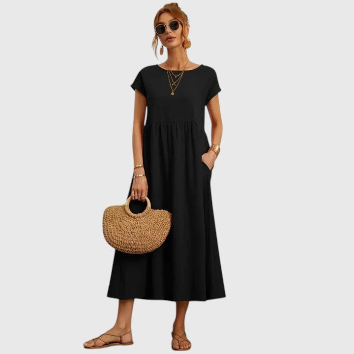 Black midi dress with short sleeves and gathered waist seam; relaxed fit.