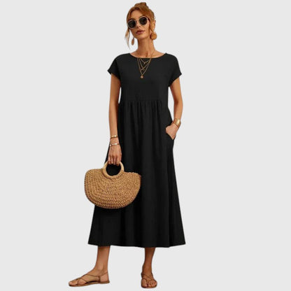 Black midi dress with short sleeves and gathered waist seam; relaxed fit.