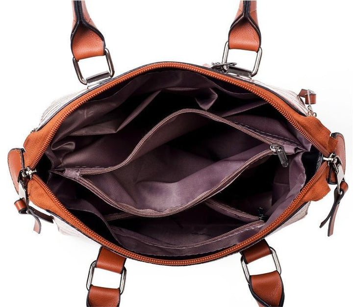 Brown croc-pattern handbag interior with zip opening and structured inner compartments