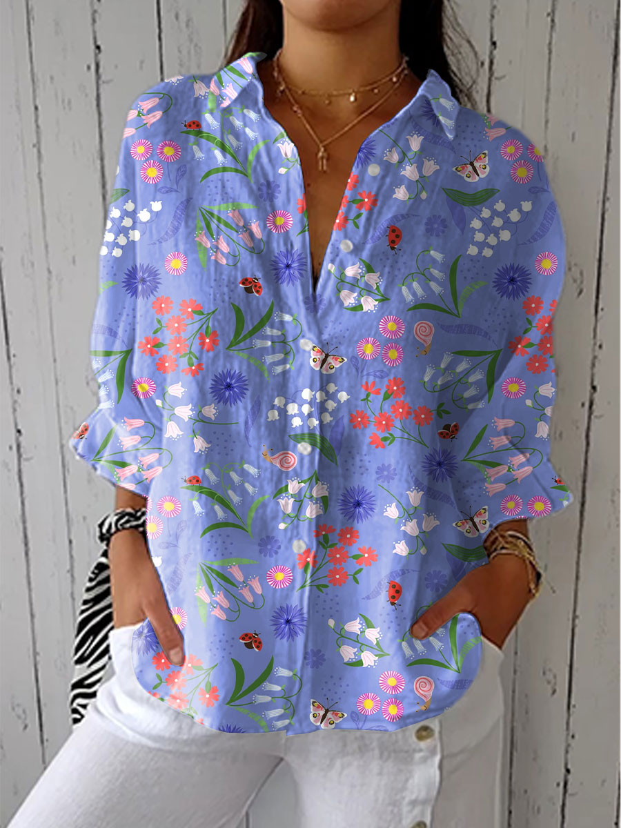 Light purple button-up blouse with colorful floral and butterfly print, long sleeves