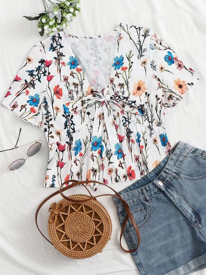 White floral v-neck flowy top with short sleeves and tied front detail