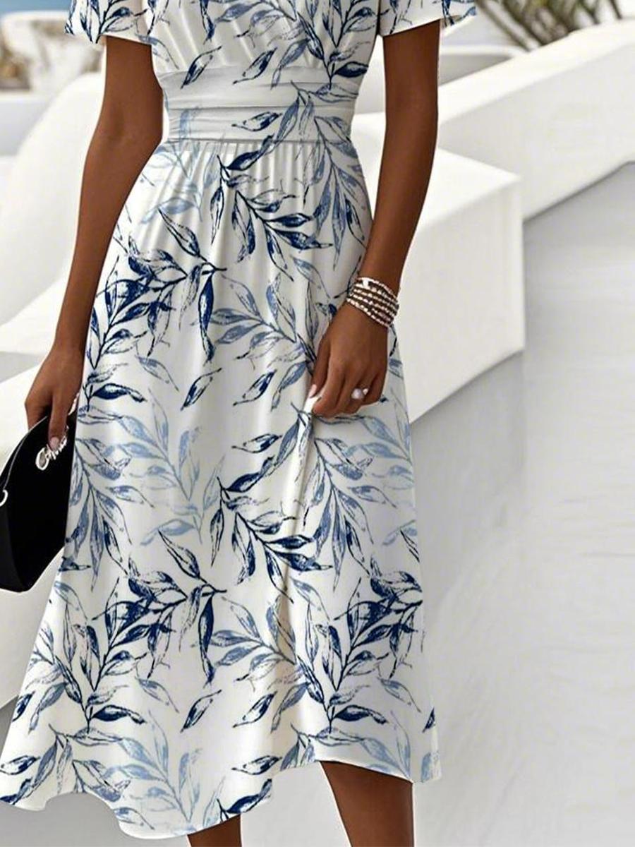 White midi dress with blue leaf print, gathered waist, flared skirt, side-length detail