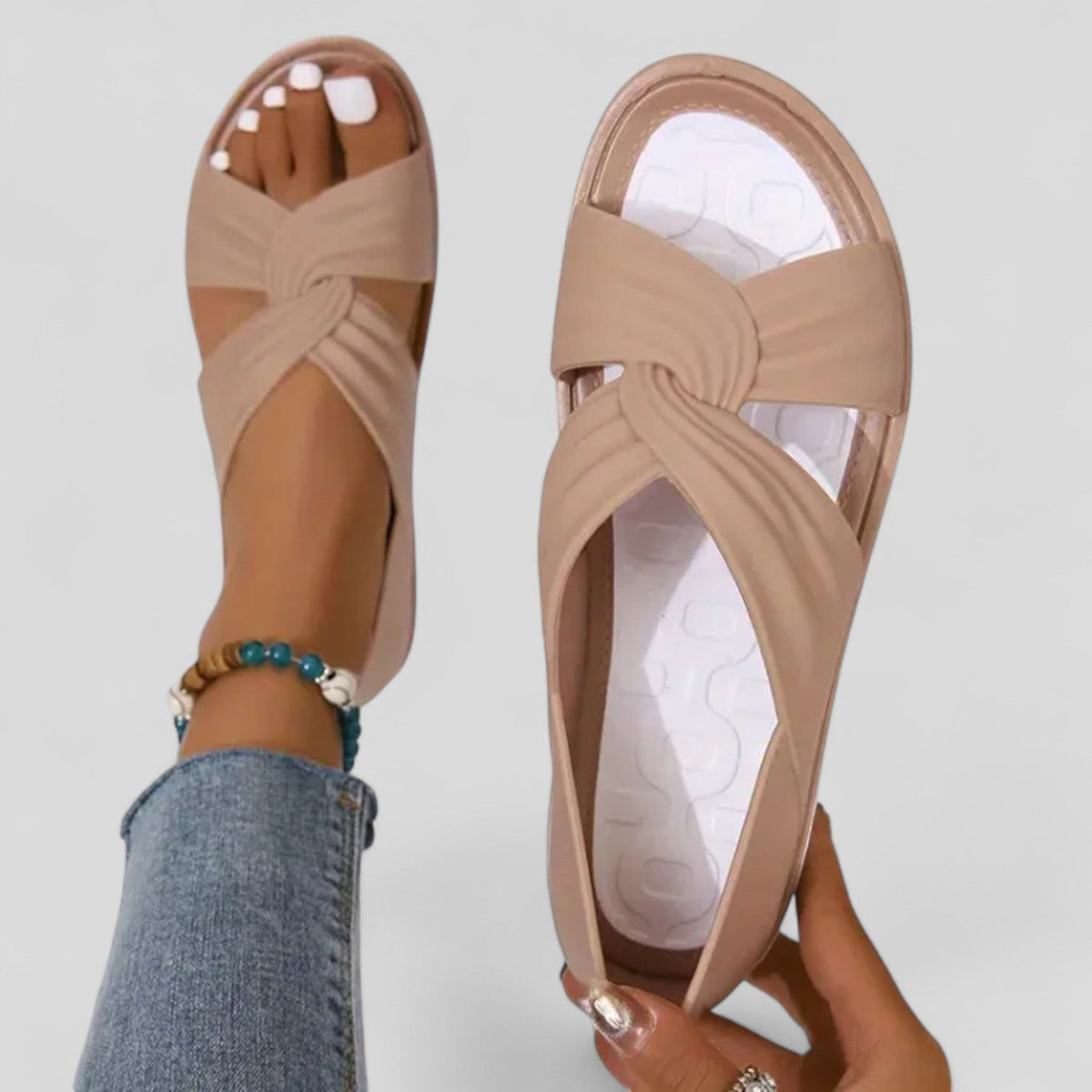 Beige orthopedic sandals with open toe and knotted crossover strap, cushioned sole