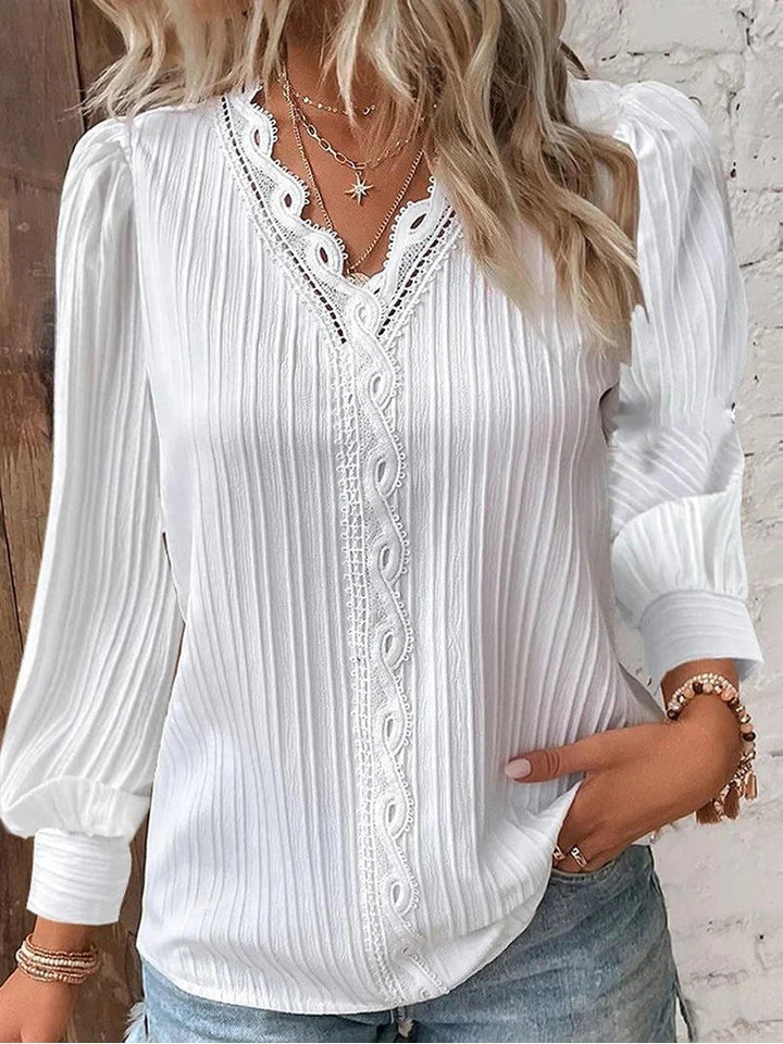 Women’s pleated top in white with V-neck lace trim and long sleeves