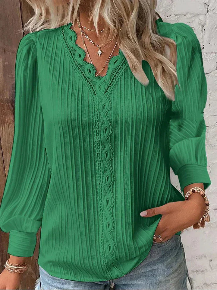 Women’s pleated top in green with V-neck lace trim and long sleeves