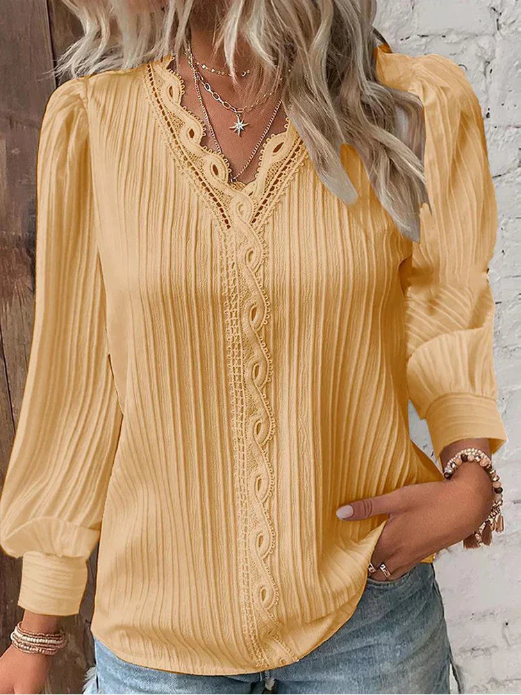 Women’s pleated top in yellow with V-neck lace trim and long sleeves
