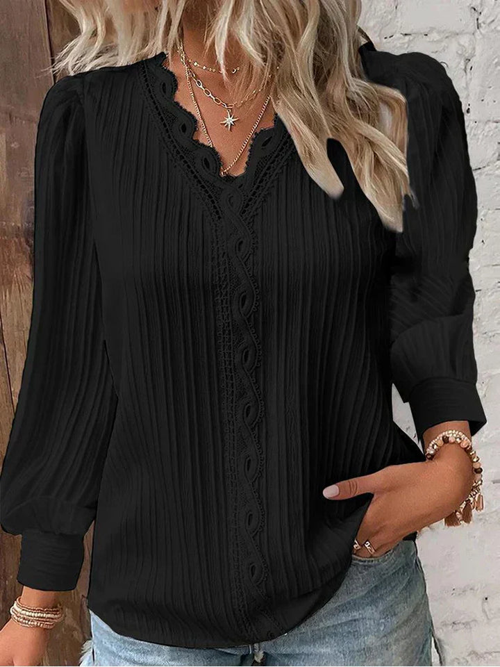 Women’s pleated top in black with V-neck lace trim and long sleeves