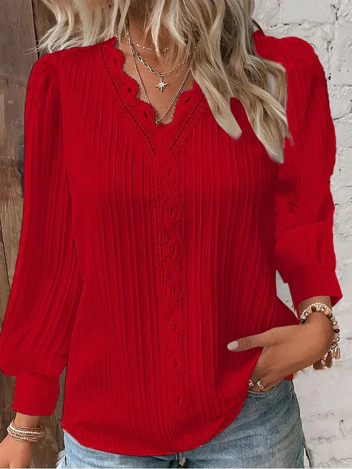 Women’s pleated top in red with V-neck lace trim and long sleeves