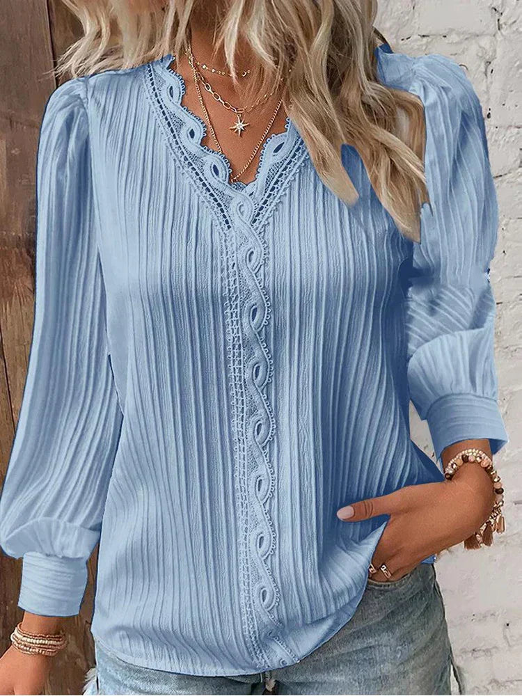 Women’s pleated top in light blue with V-neck lace trim and long sleeves