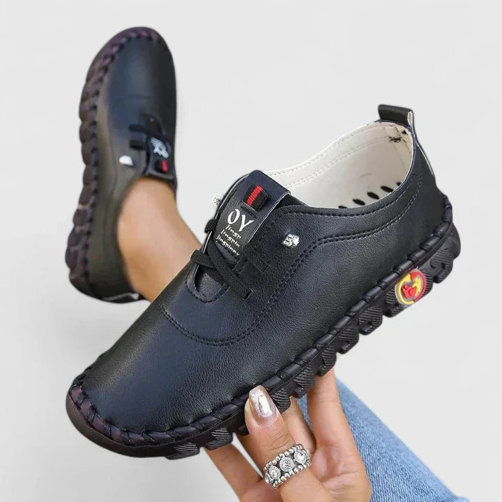 Black leather lace-up casual shoes with cushioned sole and decorative side patch