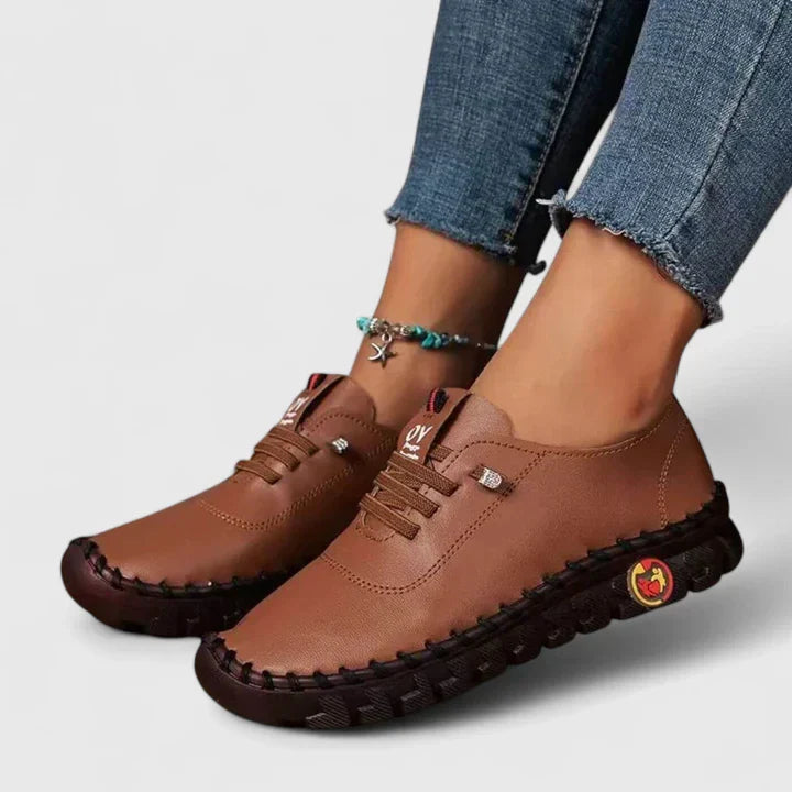 Brown leather lace-up casual shoes with chunky textured sole and side emblem