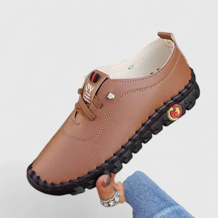 Tan leather lace-up casual shoes with black tread sole and side emblem
