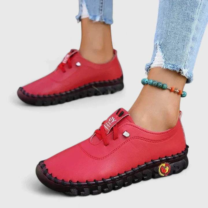 Red leather lace-up casual shoes with chunky sole and decorative side emblem