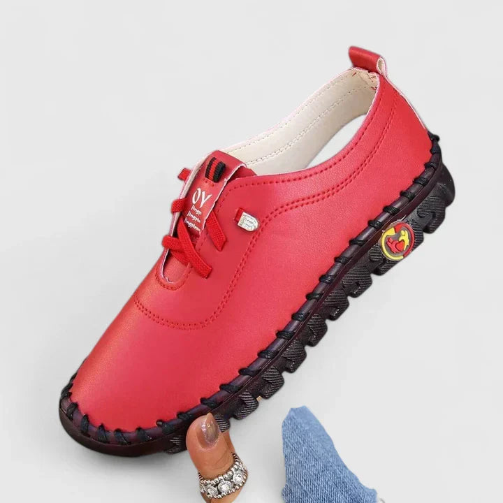 Red leather lace-up casual shoes with contrast stitching and decorative side emblem