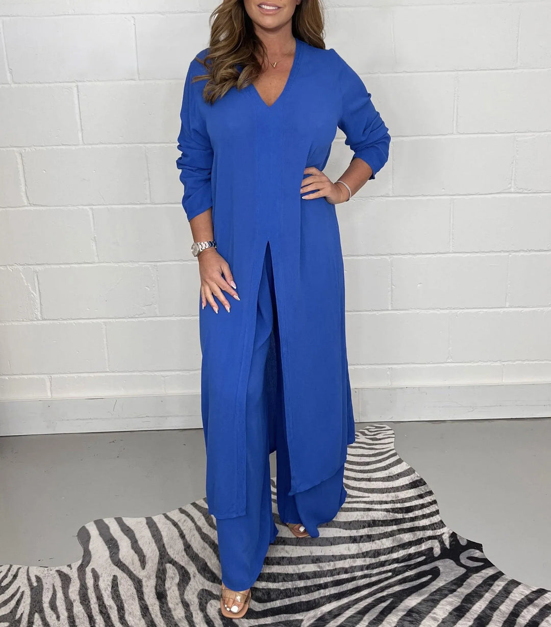 Blue two-piece set with V-neck flowy blouse and wide-leg trousers, side slit