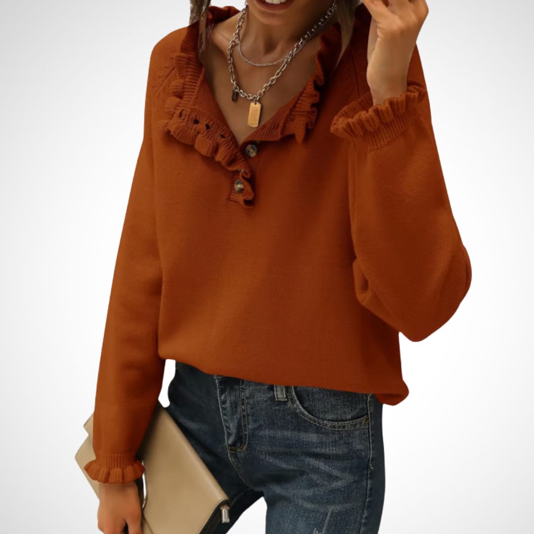 Orange long-sleeve pullover sweater with half-button placket and ruffled collar.